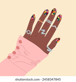 Mano femenina con elegante manicura de colores y anillos de plata. Ilustración vectorial dibujada a mano aislada sobre fondo claro. Estilo plano moderno de la historieta.