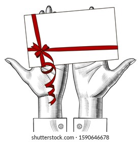 Female hands holding on the palms a Christmas greeting card with a red ribbon. Vintage color engraving stylized drawing. Vector illustration