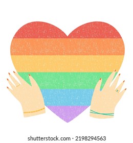 Female hands holding rainbow heart. Gay Pride. LGBT concept.