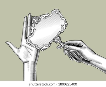 Female hands holding a retro mirror with a decorative frame. Vintage engraving stylized drawing. Vector Illustration