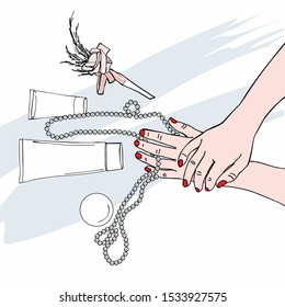 Female hands with pearl beads and tubes of creams. Hand care.