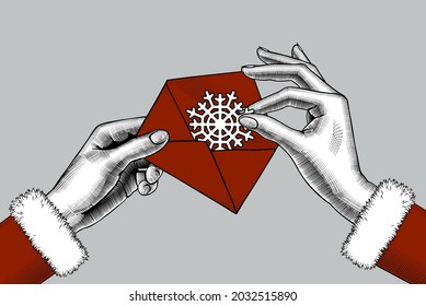 Female hands put a paper snowflake in a red mail envelope. Vintage engraving stylized drawing. Vector illustration