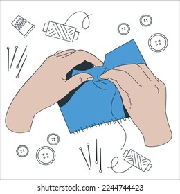 Female hands sewing button with different accessories. Process of hand made soft toys sewing with felt and needle. Closeup hands of seamstress at work with cloth fabric