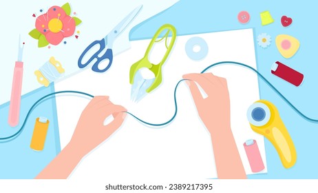 Female hands with thread on the background of a table with sewing tools