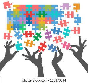 Female hands work together to connect jigsaw puzzle pieces