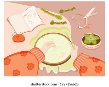 Female hobby concept. Needlework. Hands on the table with embroidery. Elements for creativity. Women. Hobby. Skeins of thread, pins, a sketch pad and a flower in a pot. Vector in flat style.