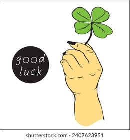 Female holding beautiful green four-leaf clover, close-up. Have  good day. Turn green. hand holds clover leaf for good luck.