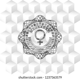 female icon inside realistic grey emblem with geometric cube white background