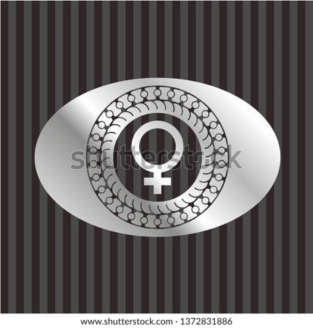 female icon inside silver badge or emblem