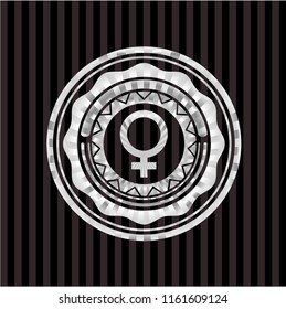 female icon inside silver emblem