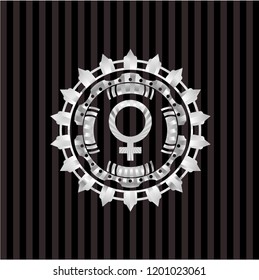 female icon inside silver emblem or badge