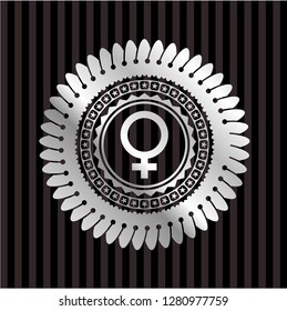 female icon inside silver emblem