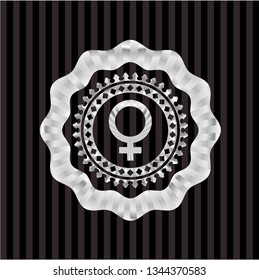 female icon inside silver emblem