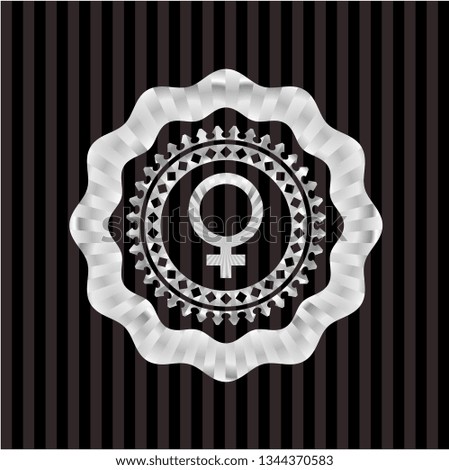 female icon inside silver emblem