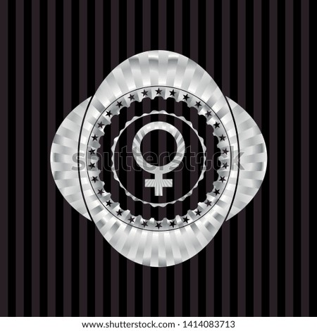 female icon inside silver shiny emblem