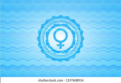 female icon inside water wave style emblem.