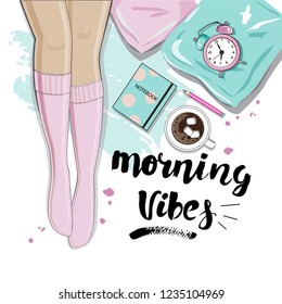 Female legs in pink socks on the bed and the inscription Morning Vibes