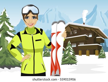 female mountain skier standing in front of a chalet in winter ski resort