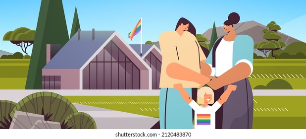 female parents walking near modular house with little daughter lesbian family transgender love LGBT community
