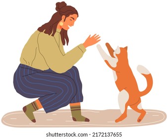 Female pet owner plays with cat. Caring for four-footed friend concept. Kitty and woman friends isolated on white background. Lady spends time with kitten, domestic animal, human companion at home
