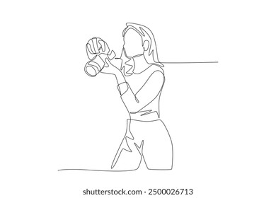 Female photographer is preparing to take a photo. World photography day concept one-line drawing