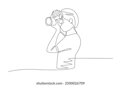 Female photographer is taking photos. World photography day concept one-line drawing