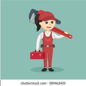 female plumber holding tool box and giant pipe wrench