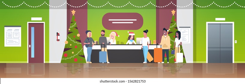 female receptionists in santa hats meeting mix race tourists with luggage at reception counter registration christmas holiday concept modern hotel lobby interior flat full length horizontal vector