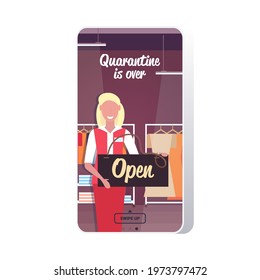 female shop assistant holding open sign board coronavirus quarantine is ending victory over covid-19