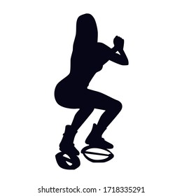 Female silhouette doing squat in special boots. Girl doing strength exercise in bounce shoes during high intensity interval training (HIIT). Cardio fitness and weight loss. 