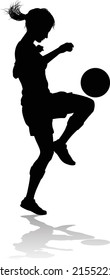 A female soccer football player woman in silhouettes