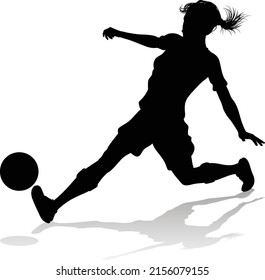 A female soccer football player woman in silhouettes
