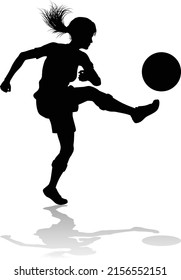A female soccer football player woman in silhouettes