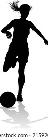 A female soccer football player woman in silhouettes