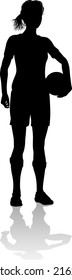 A female soccer football player woman in silhouettes