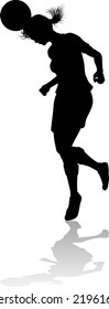 A female soccer football player woman in silhouettes