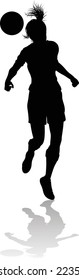 A female soccer football player woman in silhouettes