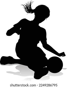 A female soccer football player woman in silhouettes