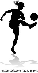 A female soccer football player woman in silhouettes