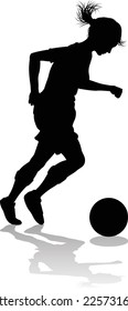 A female soccer football player woman in silhouettes