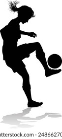 A female soccer football player woman in silhouettes