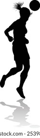 A female soccer football player woman in silhouettes