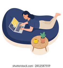A female software developer works comfortably while lying on a blue bean bag chair. She types code on her laptop next to a small wooden table with a coffee mug and potted plant. This scene represents relaxed remote work.