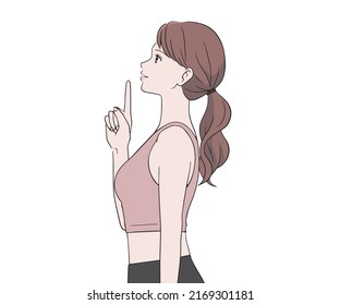 Female sports instructor pointing her finger with a smile
