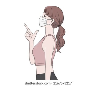 Female sports instructor wearing a mask and pointing her finger