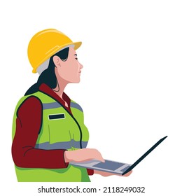 female worker checking with laptop wearing safety body protector and helmet