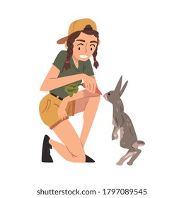 Female Zoo Worker Feeding Rabbit with Fresh Carrot, Veterinarian or Professional Zookeeper Character Caring of Wild Animals in Zoo Cartoon Vector Illustration