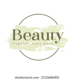 Feminine badge. Elegant green brush watercolor background logo with round frame. Beautiful badge for branding and card composition design concept