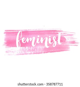Feminist word, white inscription at pastel pink watercolor stroke. Vector lettering for cards, posters and t-shirt