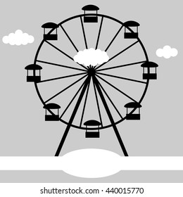 Ferris wheel on the background of clouds